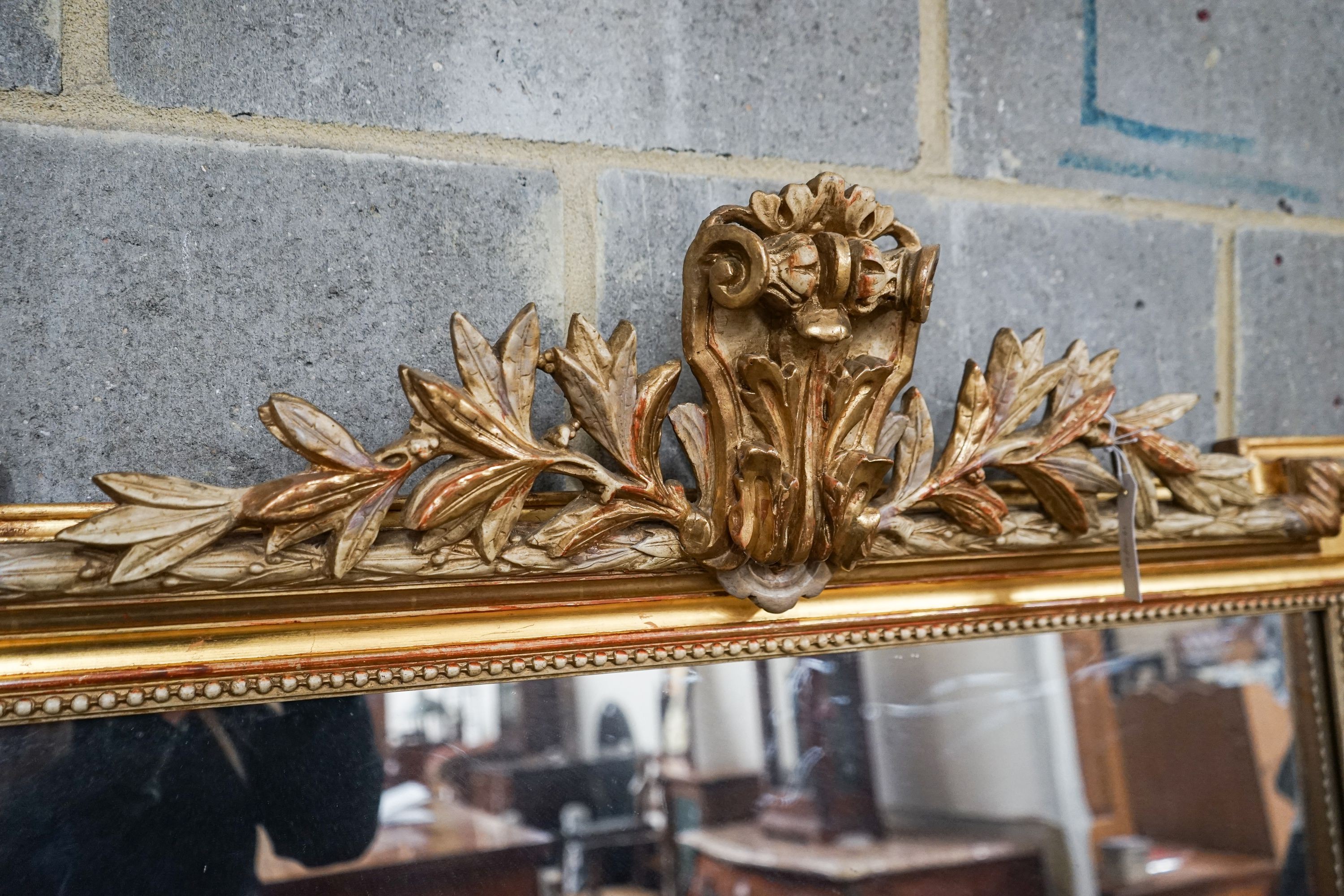 A large Victorian style rectangular carved giltwood overmantel mirror, width 109cm, height 156cm